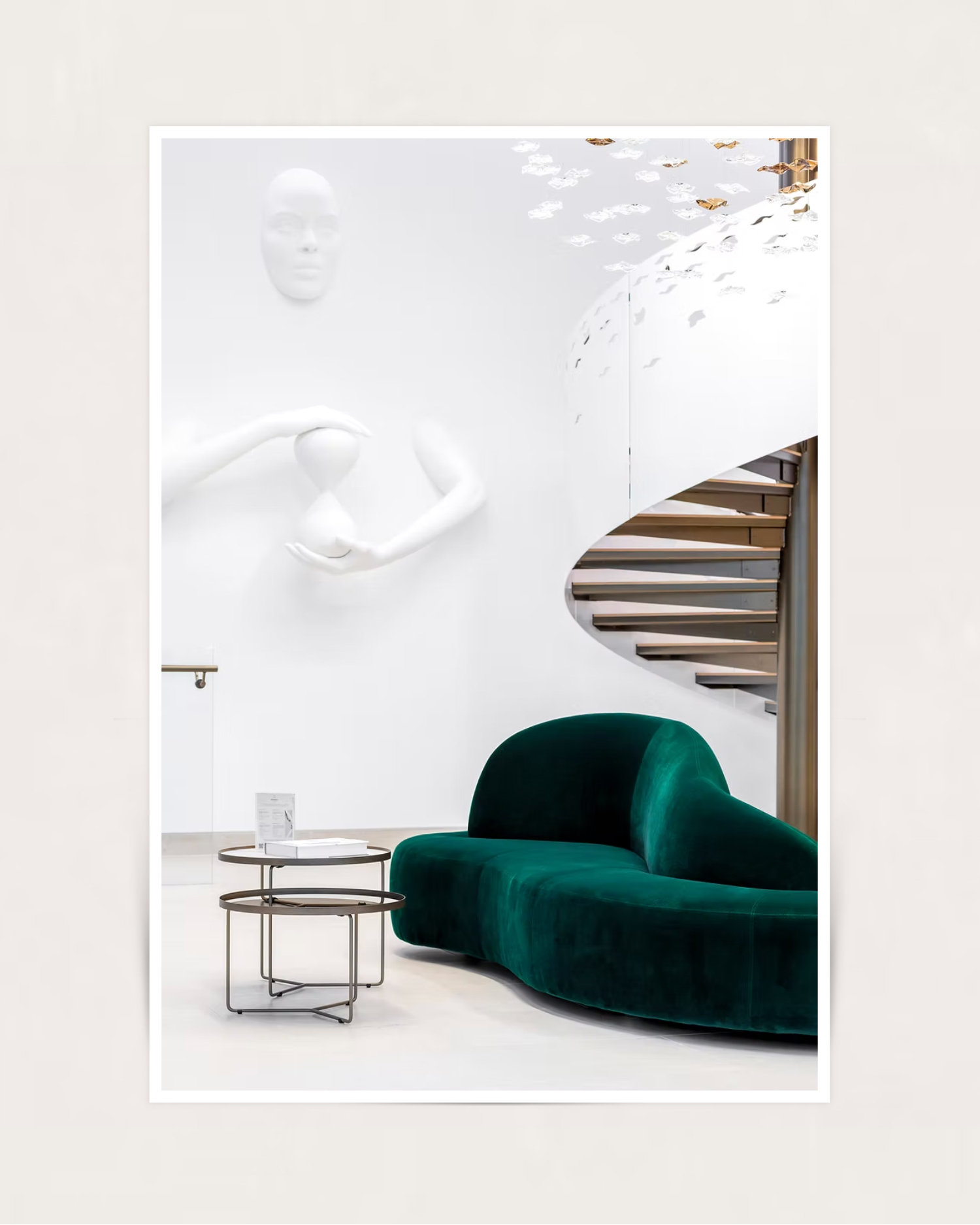3D sculpture installed at Remedi London - white abstract figure with spiral staircase and emerald velvet sofa
