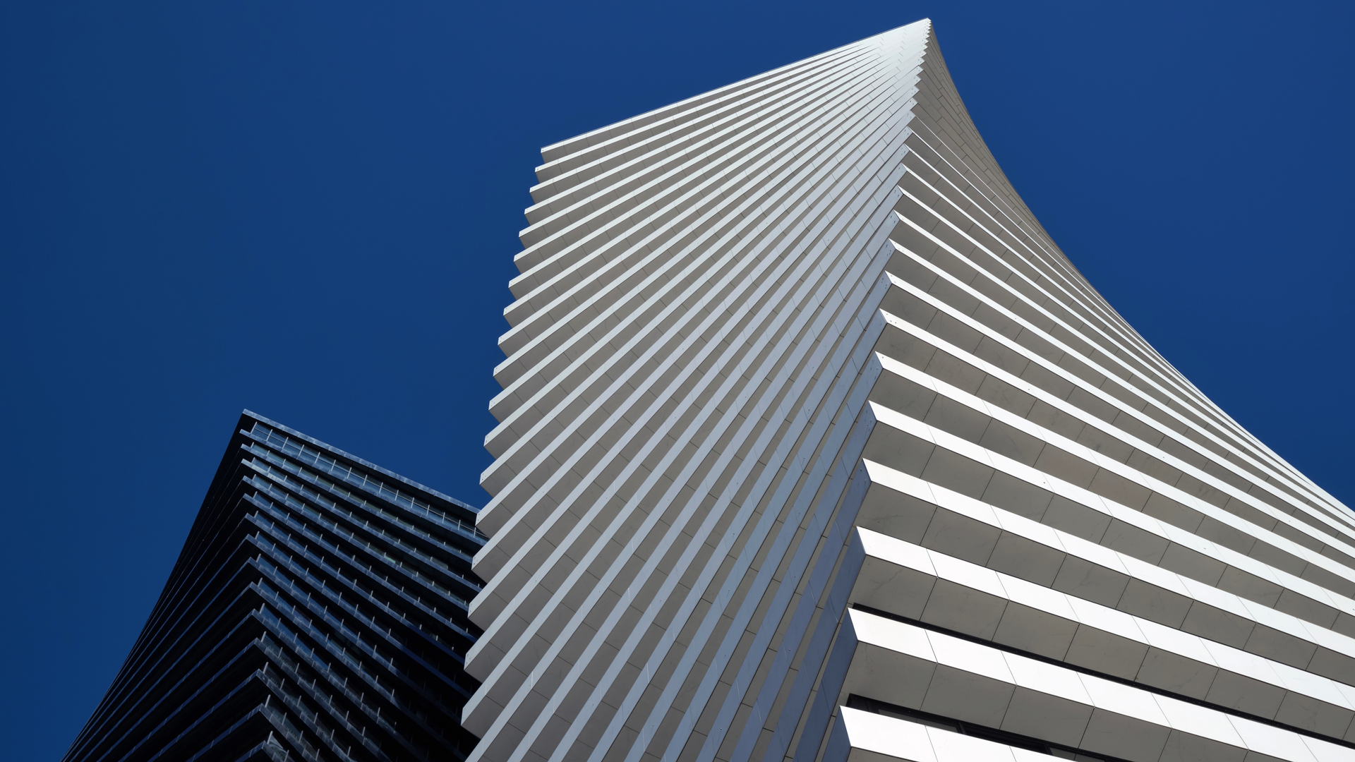 Modern luxury residential towers against blue sky